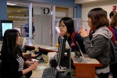 Students at the Performing Arts Library circulation counter